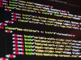 Close-up of HTML code highlighted in vibrant colors on a computer monitor.