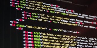 Close-up of HTML code highlighted in vibrant colors on a computer monitor.