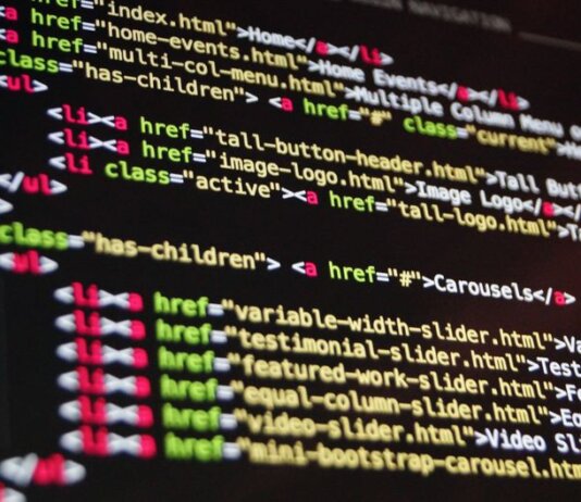 Close-up of HTML code highlighted in vibrant colors on a computer monitor.