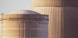 Студенты Western University исследуют безопасность ядерного хранилища Close-up view of nuclear reactor buildings bathed in golden light, showcasing industrial architecture.