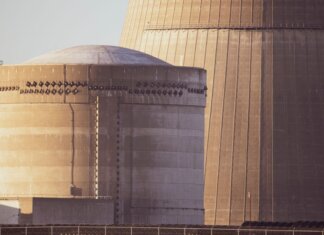 Студенты Western University исследуют безопасность ядерного хранилища Close-up view of nuclear reactor buildings bathed in golden light, showcasing industrial architecture.