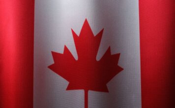 Close-up view of the Canadian flag with its iconic red maple leaf.