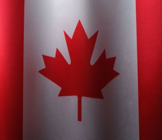 Close-up view of the Canadian flag with its iconic red maple leaf.