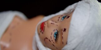 Conceptual image of a mannequin depicting plastic surgery with marker lines.