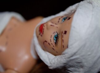 Conceptual image of a mannequin depicting plastic surgery with marker lines.
