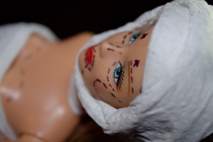 Conceptual image of a mannequin depicting plastic surgery with marker lines. Conceptual image of a mannequin depicting plastic surgery with marker lines.