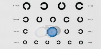 Contact lens case on top of eye test chart for optometric examinations.