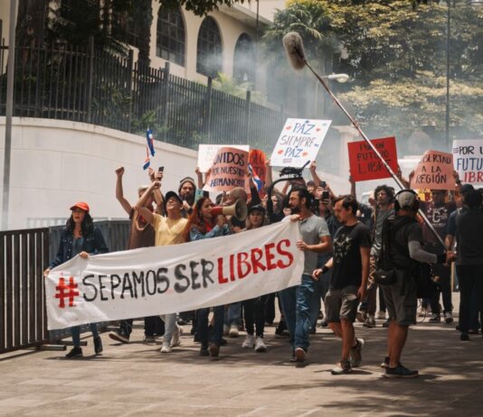 Demonstrators holding banners and signs during a peaceful protest in San José, Costa Rica.