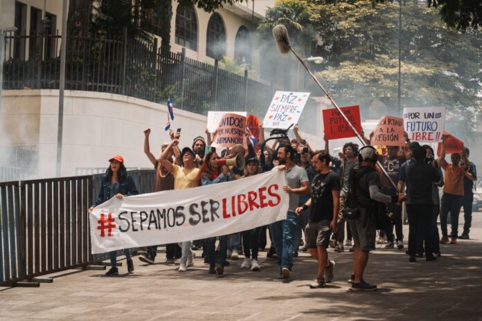 Demonstrators holding banners and signs during a peaceful protest in San José, Costa Rica. Demonstrators holding banners and signs during a peaceful protest in San José, Costa Rica.