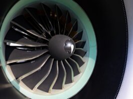 Detailed close-up of jet engine turbine blades showcasing engineering precision on an aircraft.