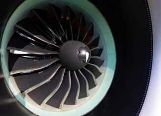 Detailed close-up of jet engine turbine blades showcasing engineering precision on an aircraft.