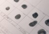 Полиция Гамильтона разыскивает 15-летнего подростка за двойное убийство Detailed fingerprints on official document, highlighting identity verification process.