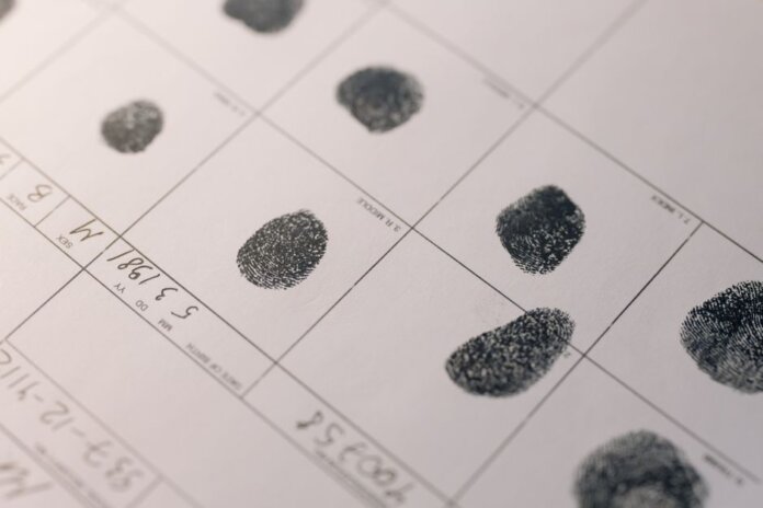 Detailed fingerprints on official document, highlighting identity verification process. Detailed fingerprints on official document, highlighting identity verification process.