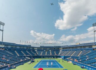 Dynamic tennis match in progress at an outdoor stadium in Toronto 2015 event, with vibrant sky and audience.