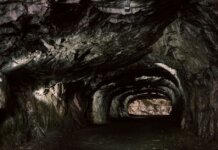 Explore the mysterious rocky tunnel with natural geological formations.
