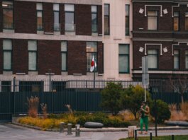 Exterior of the Japanese Embassy in Kyiv, featuring the national flag and urban landscape.