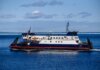 Ferry navigating clear blue North Atlantic waters near Bell Island, NL, Canada.