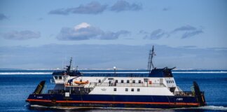 Ferry navigating clear blue North Atlantic waters near Bell Island, NL, Canada.