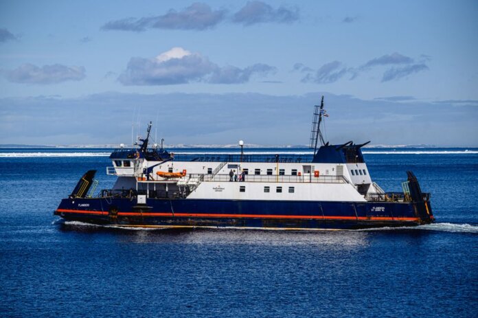Ferry navigating clear blue North Atlantic waters near Bell Island, NL, Canada. Ferry navigating clear blue North Atlantic waters near Bell Island, NL, Canada.