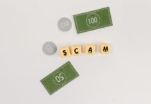 Flat lay of fake currency and scam letters on a gray surface representing financial deception.