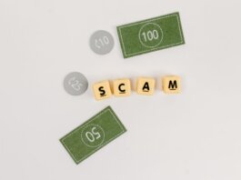 Flat lay of fake currency and scam letters on a gray surface representing financial deception.