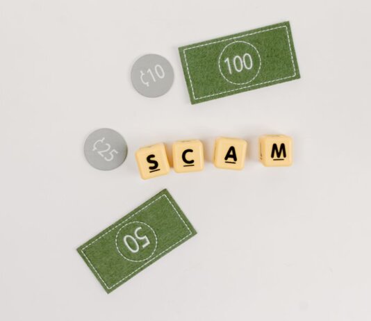 Flat lay of fake currency and scam letters on a gray surface representing financial deception.