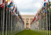 Канада объявила о новых дипломатических назначениях From below of various flags on flagpoles located in green park in front of entrance to the UN headquarters in Geneva