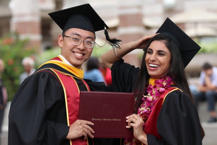 Happy graduates celebrating their achievement at University of Southern California. Happy graduates celebrating their achievement at University of Southern California.
