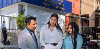 Legal consultation outside the Piura District Office, Piura, Peru. People discussing documents.