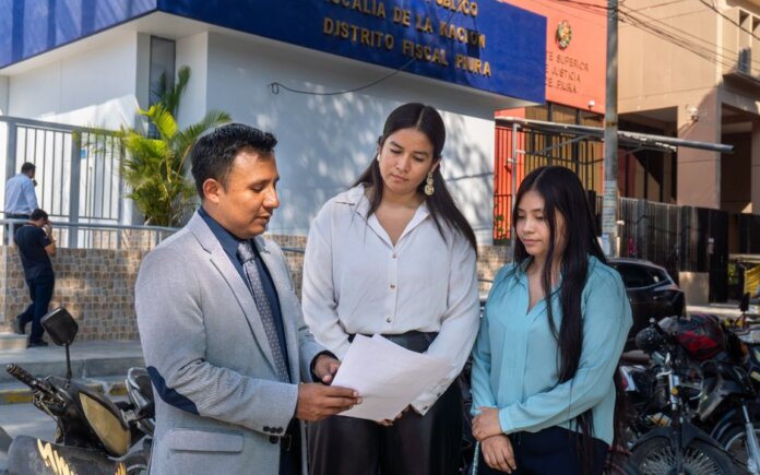 Legal consultation outside the Piura District Office, Piura, Peru. People discussing documents. Legal consultation outside the Piura District Office, Piura, Peru. People discussing documents.