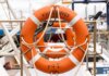 Канада вводит защитные пошлины на импорт консервированных овощей Orange lifebuoy labeled 'Vancouver' on a docked boat, ready for safety and rescue.