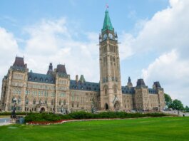 Stunning photo of Canada's Parliament Hill in Ottawa under a clear sky, showcasing Gothic Revival architecture.