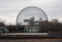 Stunning view of Montreal's Biosphere, an iconic geodesic dome, under a cloudy sky.