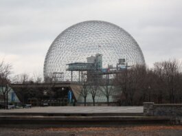 Stunning view of Montreal's Biosphere, an iconic geodesic dome, under a cloudy sky.