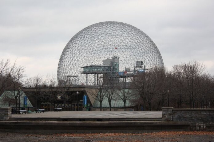 Stunning view of Montreal's Biosphere, an iconic geodesic dome, under a cloudy sky. Stunning view of Montreal's Biosphere, an iconic geodesic dome, under a cloudy sky.
