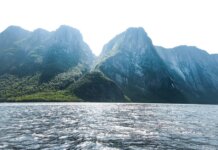 Stunning view of towering mountains and shimmering sea in Gros Morne, Newfoundland, Canada.