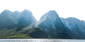 Stunning view of towering mountains and shimmering sea in Gros Morne, Newfoundland, Canada.