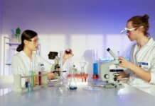 Two scientists working in a well-equipped laboratory conducting chemical research and experiments.