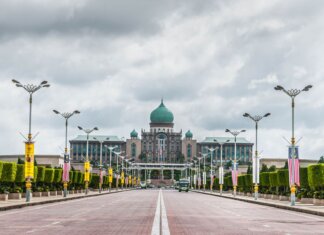 View of the Perdana Putra building, a landmark of Malaysian architecture, from a street perspective.