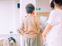 Young child being examined by a medical professional in a healthcare environment.