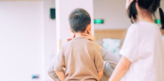 Young child being examined by a medical professional in a healthcare environment.