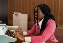 Канада продаст военную технику частному сектору для помощи в ЧС A businesswoman typing in a vintage office setting, highlighting the retro style and classic workplace ambiance.