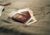 CBSA предъявило 12 обвинений по делу об иммиграционном мошенничестве A close-up of a Polish passport and travel documents placed on a fabric surface, symbolizing travel and identity.
