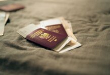 A close-up of a Polish passport and travel documents placed on a fabric surface, symbolizing travel and identity.