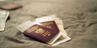 CBSA предъявило 12 обвинений по делу об иммиграционном мошенничестве A close-up of a Polish passport and travel documents placed on a fabric surface, symbolizing travel and identity.