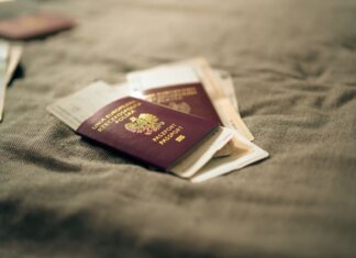 A close-up of a Polish passport and travel documents placed on a fabric surface, symbolizing travel and identity.