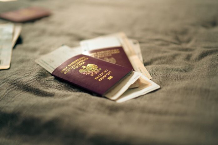 A close-up of a Polish passport and travel documents placed on a fabric surface, symbolizing travel and identity. A close-up of a Polish passport and travel documents placed on a fabric surface, symbolizing travel and identity.