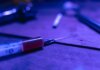 A close-up of a syringe with a dark and moody tone, symbolizing addiction and treatment.