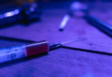 A close-up of a syringe with a dark and moody tone, symbolizing addiction and treatment.