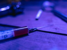 A close-up of a syringe with a dark and moody tone, symbolizing addiction and treatment.